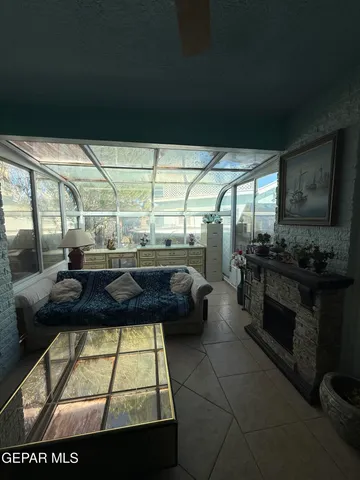 a living room with furniture gym equipment and a large window