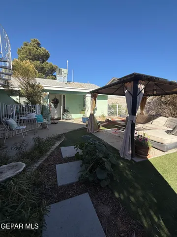 a view of a backyard with plants and outdoor seating