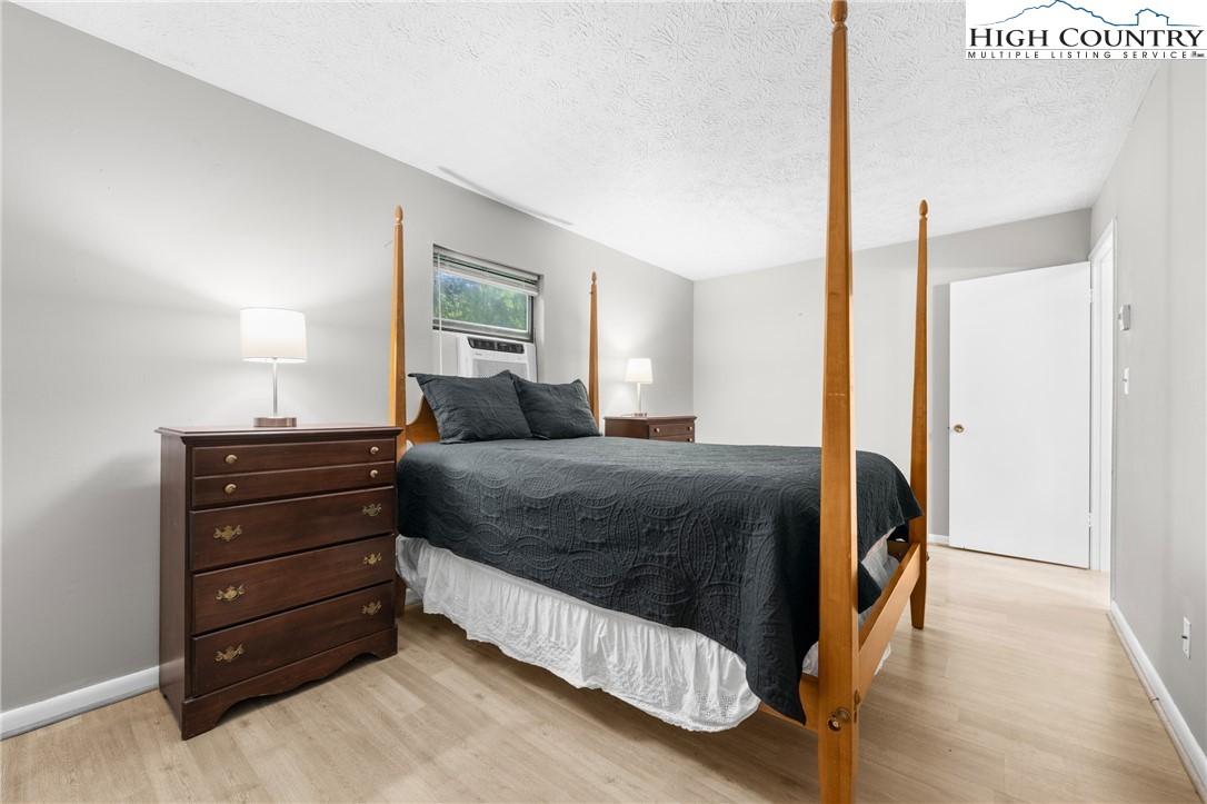 1469 West King Street, Unit 201 Boone, NC 28607 - Photo 14 of 19 a bedroom with a bed and a dresser