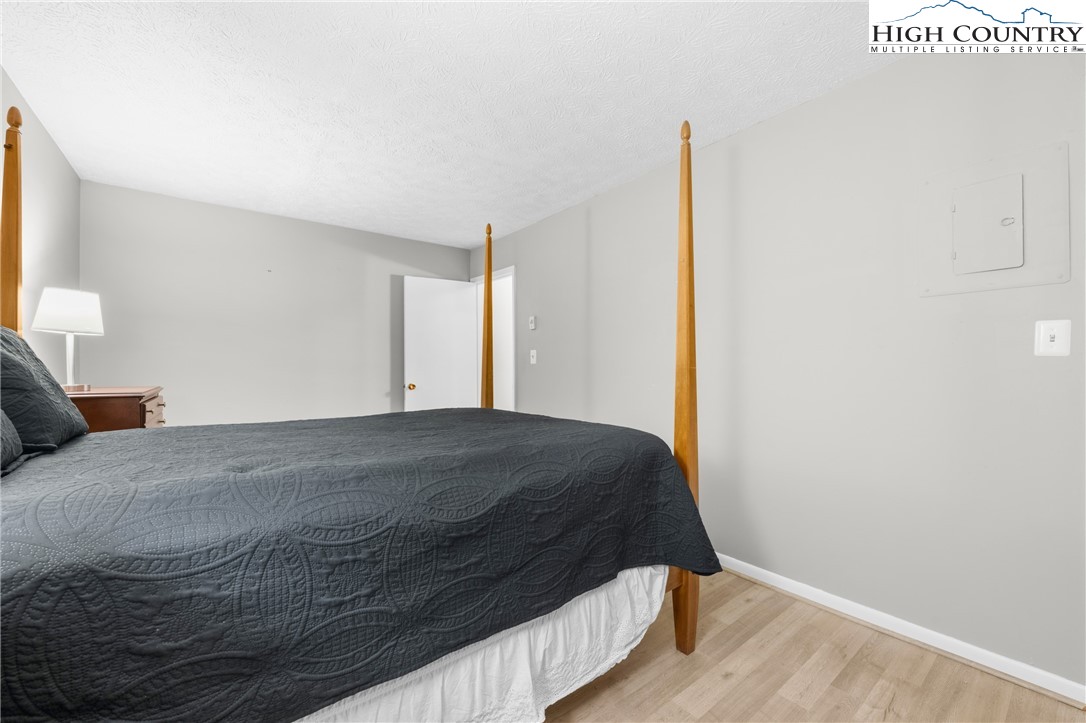 1469 West King Street, Unit 201 Boone, NC 28607 - Photo 15 of 19 a bedroom with a bed and wooden floor