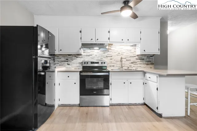 a kitchen with stainless steel appliances granite countertop a stove a refrigerator and a granite counter tops