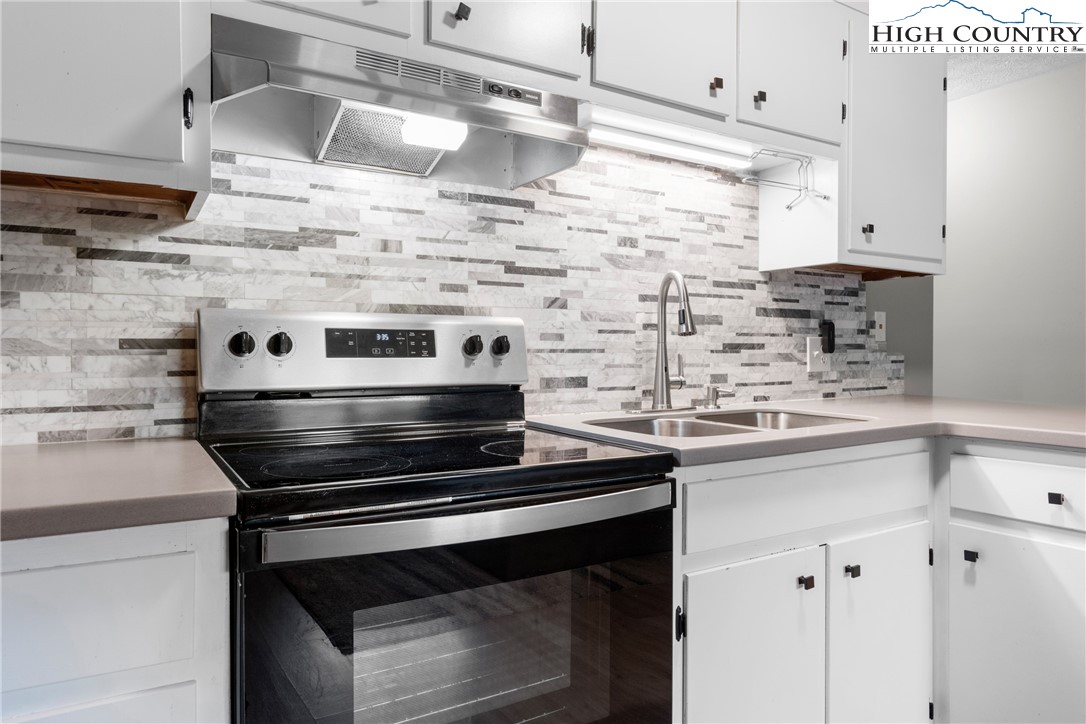 1469 West King Street, Unit 201 Boone, NC 28607 - Photo 5 of 19 a stove top oven sitting inside of a kitchen