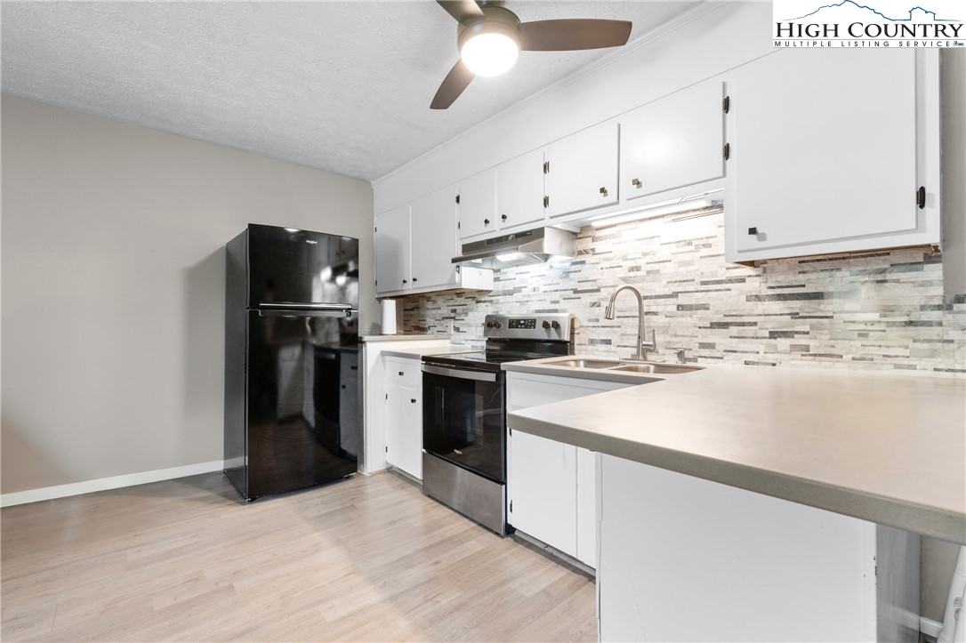 1469 West King Street, Unit 201 Boone, NC 28607 - Photo 6 of 19 a kitchen with refrigerator and cabinets