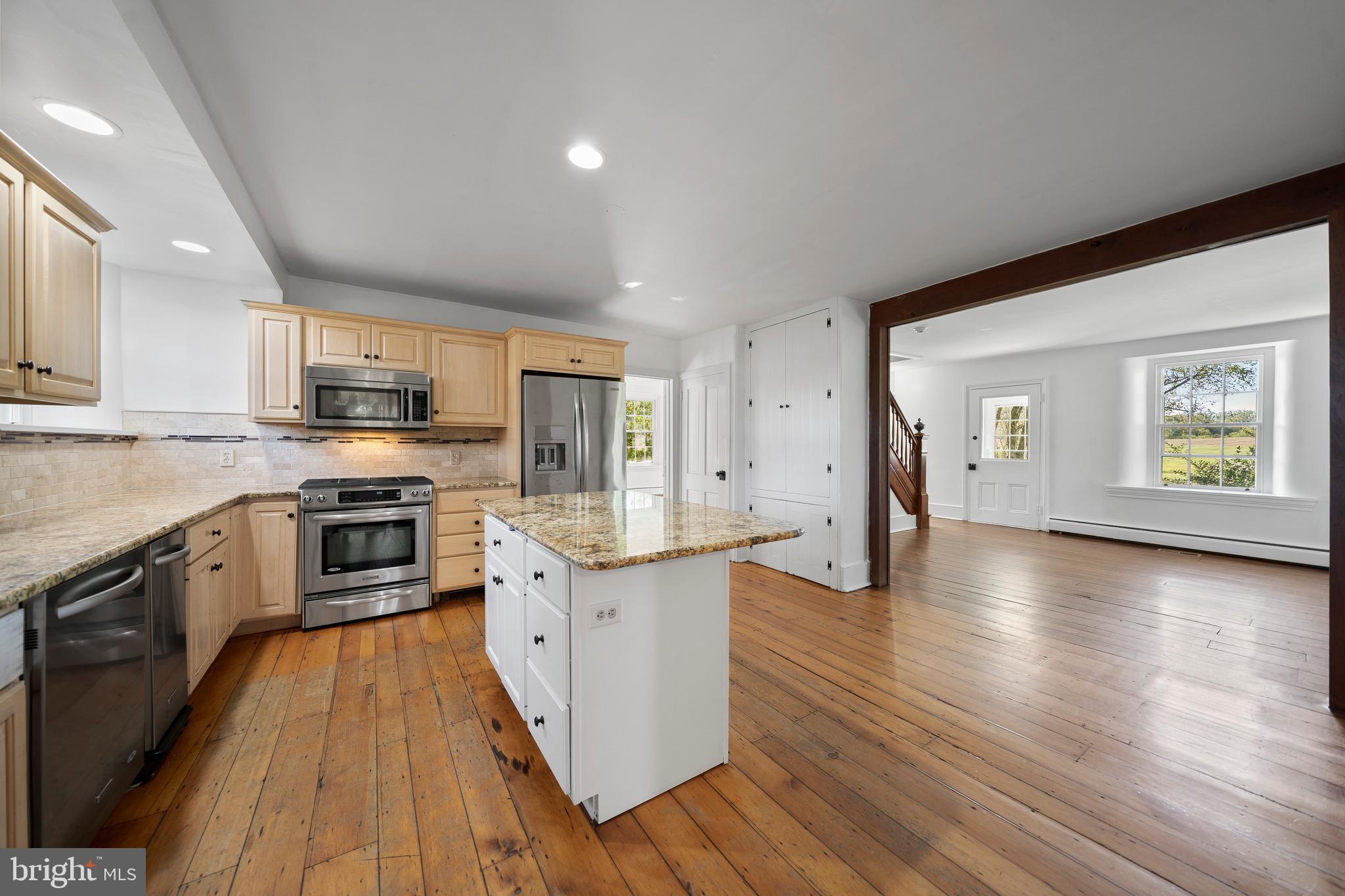 1025 North Chatham Road West Grove, PA 19390 - Photo 12 of 44 a large kitchen with stainless steel appliances granite countertop a stove a sink dishwasher and a microwave oven with wooden floor