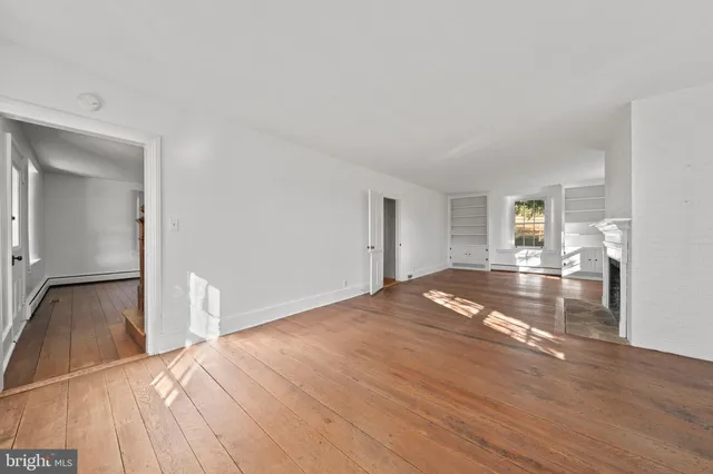 a view of a livingroom with wooden floor and a flat screen tv
