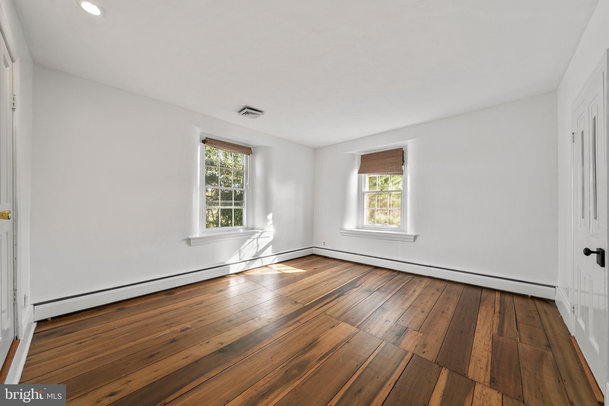 1025 North Chatham Road West Grove, PA 19390 - Photo 22 of 44 a view of an empty room with wooden floor and a window