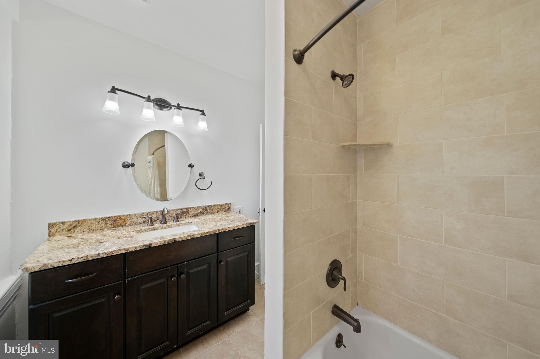 1025 North Chatham Road West Grove, PA 19390 - Photo 27 of 44 a bathroom with a granite countertop sink a mirror and a shower