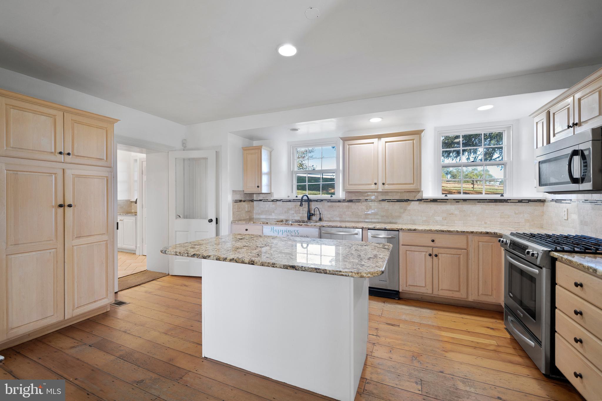 1025 North Chatham Road West Grove, PA 19390 - Photo 9 of 44 a kitchen with stainless steel appliances granite countertop a sink a stove a refrigerator and island with wooden floor