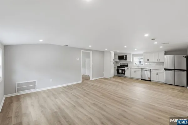 a view of kitchen with wooden floor