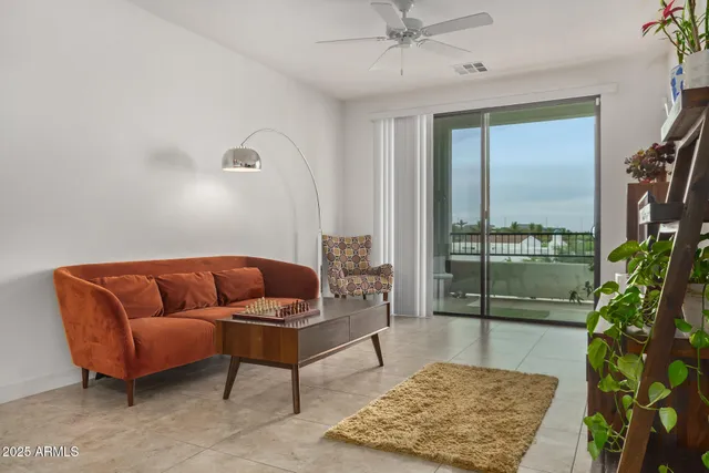 a living room with furniture and a potted plant