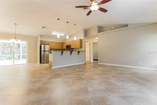 a view of a kitchen with a stove and a ceiling fan