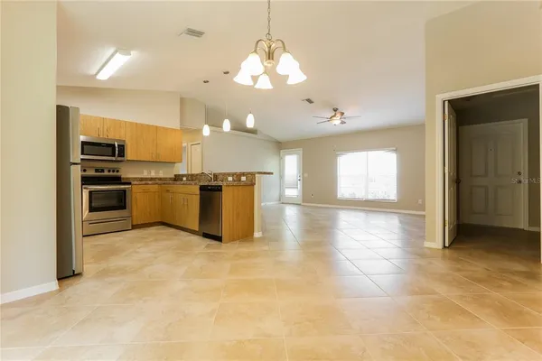 a view of a kitchen with a sink and stainless steel appliances