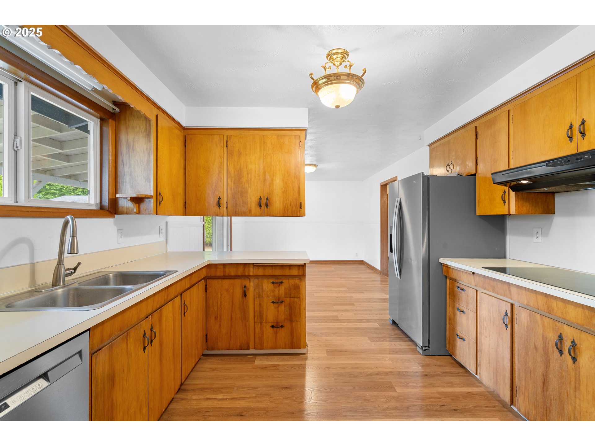 1897 Chelan Street Northeast Keizer, OR 97303 - Photo 11 of 39 a kitchen with stainless steel appliances granite countertop a sink cabinets and wooden floor