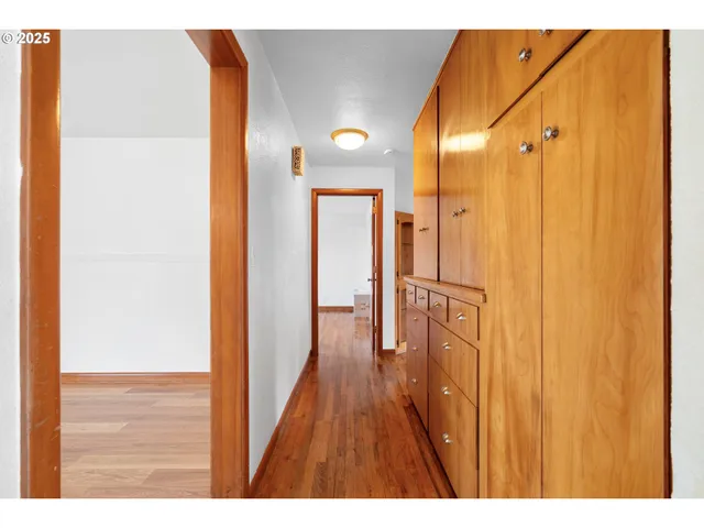 a view of an entryway with wooden floor and door