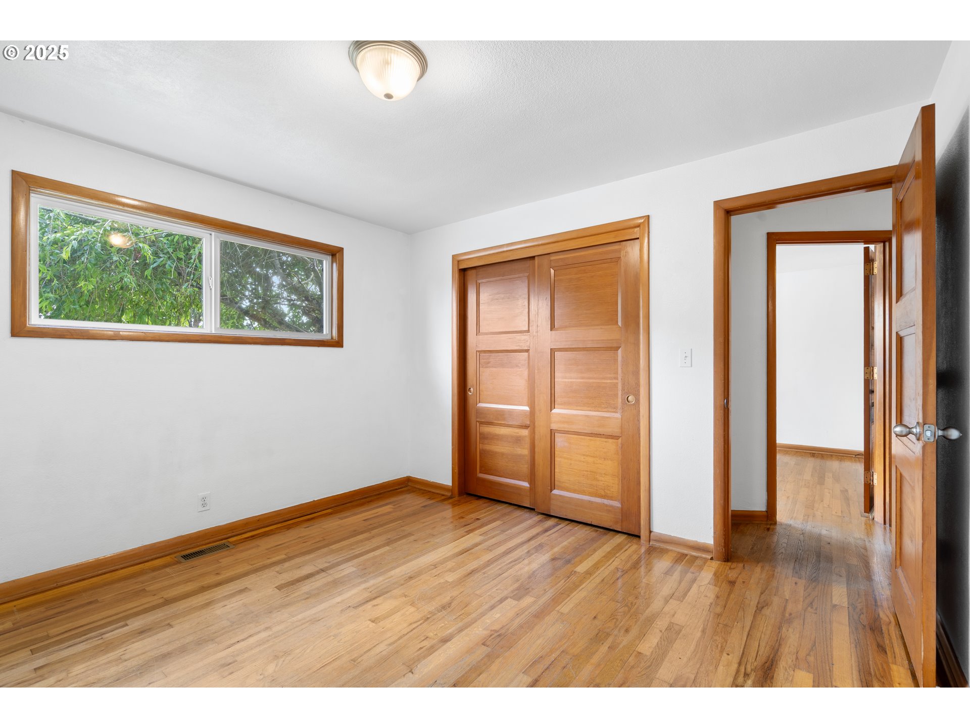 1897 Chelan Street Northeast Keizer, OR 97303 - Photo 20 of 39 an empty room with wooden floor and windows