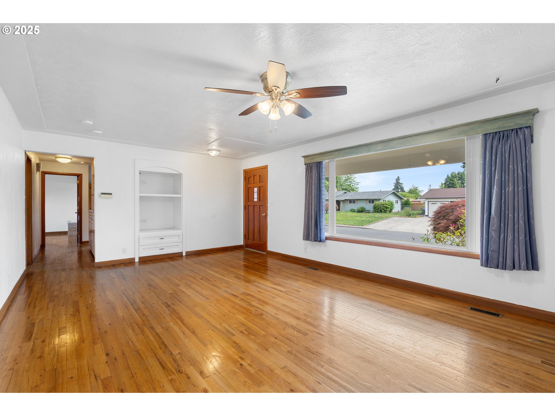 1897 Chelan Street Northeast Keizer, OR 97303 - Photo 6 of 39 a view of an empty room with window and wooden floor