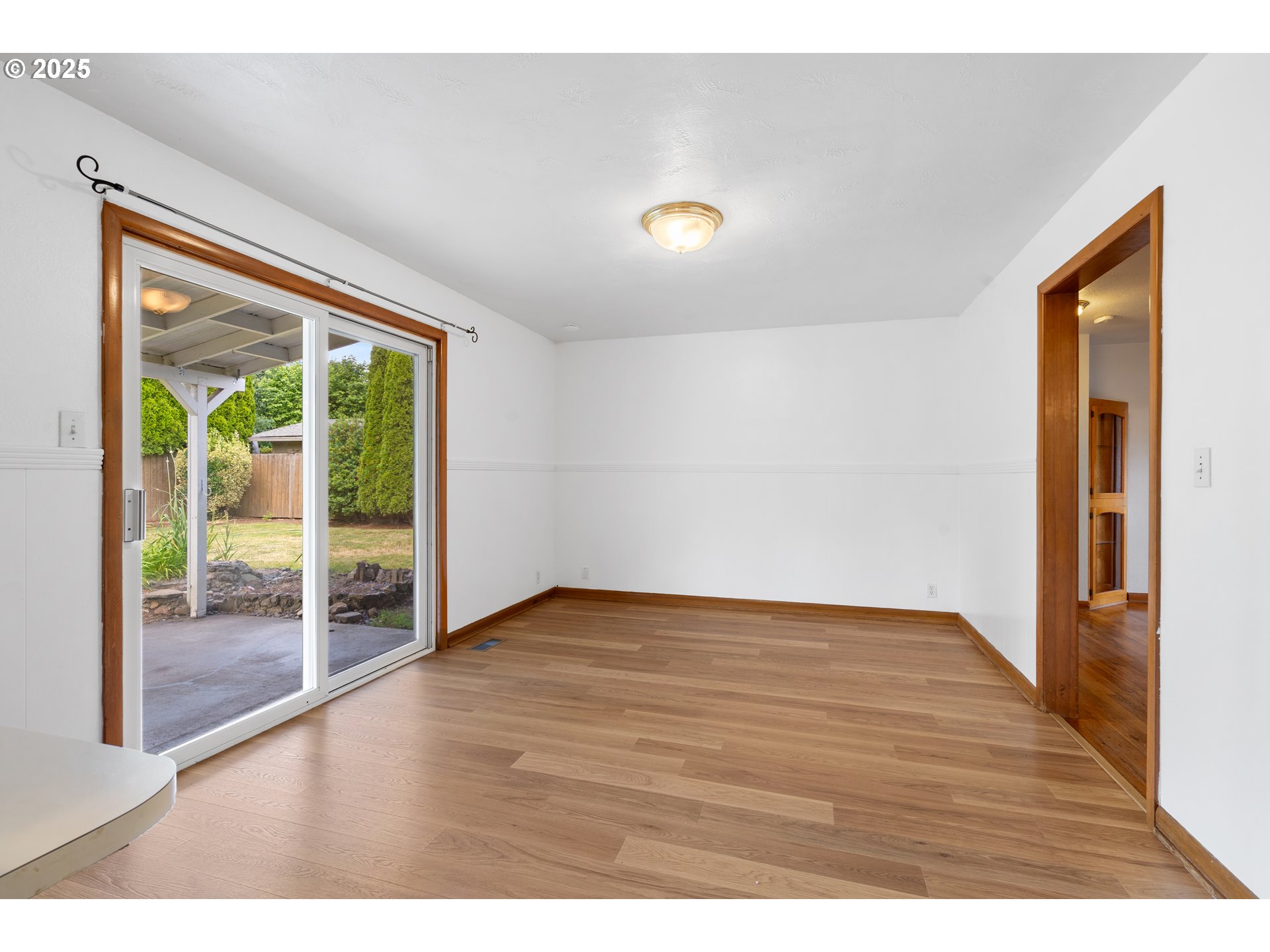 1897 Chelan Street Northeast Keizer, OR 97303 - Photo 9 of 39 a view of an empty room with wooden floor and a window
