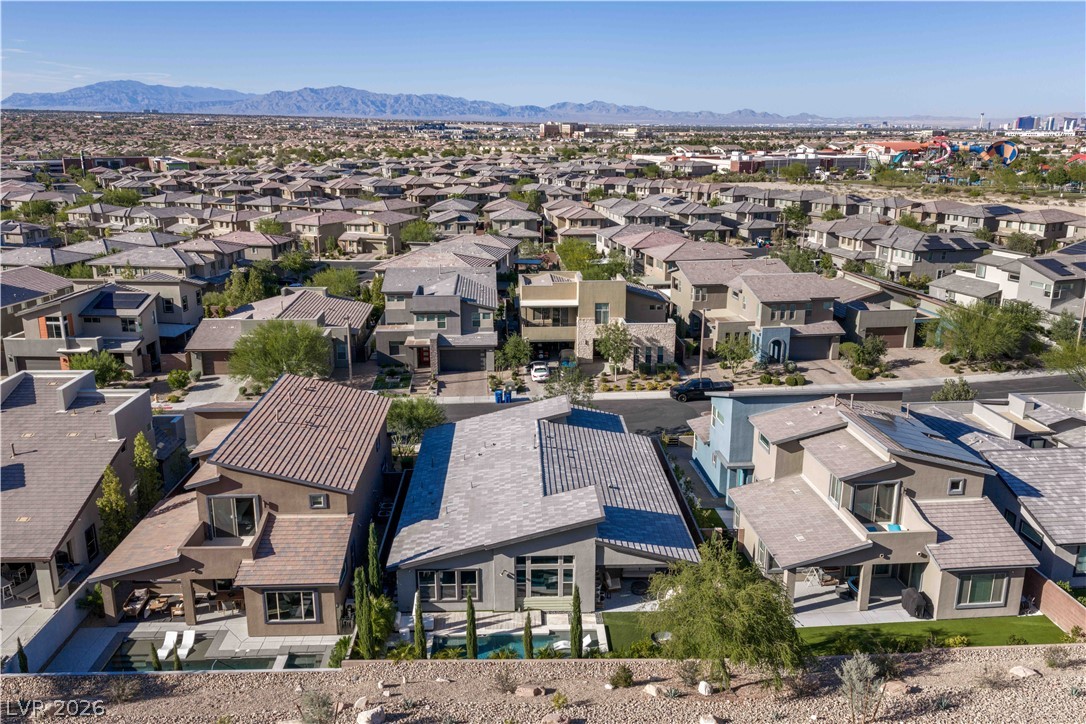 9719 Starlight Ridge Avenue Las Vegas, NV 89148 - Photo 27 of 27 An aerial perspective reveals a modern residential development with uniform architecture and stunning mountain views.