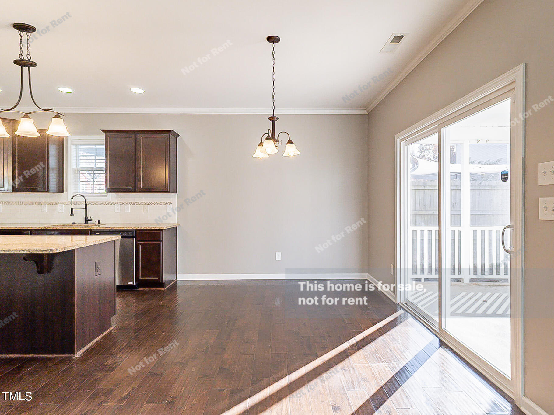 191 Verrazano Place Clayton, NC 27520 - Photo 2 of 28 a view of a kitchen with kitchen island a large window a sink and a counter top space