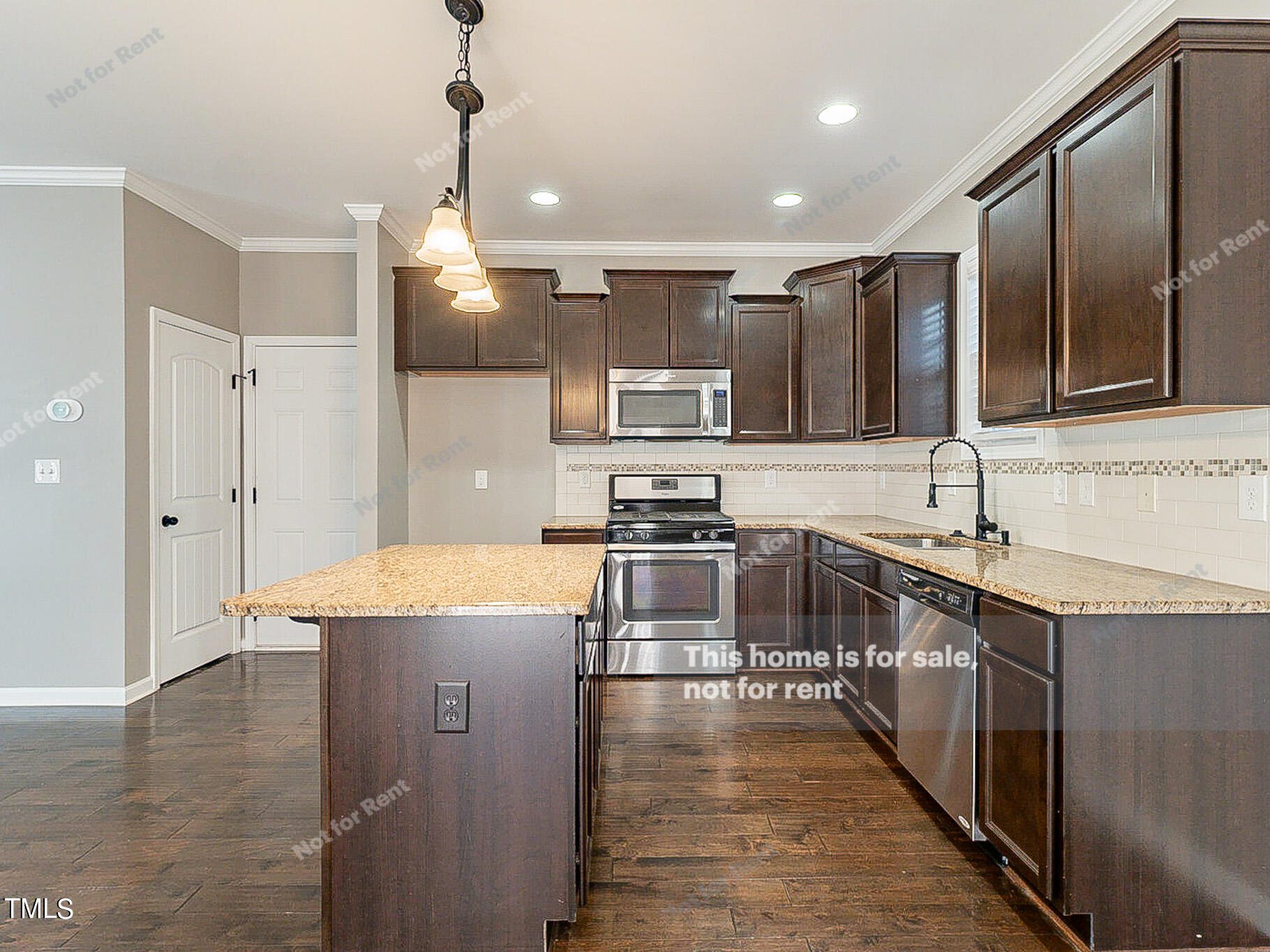191 Verrazano Place Clayton, NC 27520 - Photo 6 of 28 a large kitchen with stainless steel appliances kitchen island granite countertop a sink stove and refrigerator