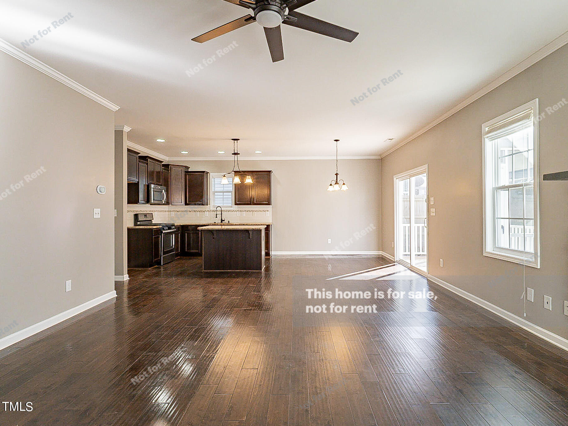 191 Verrazano Place Clayton, NC 27520 - Photo 9 of 28 a view of a kitchen with kitchen island wooden floors appliances and a window
