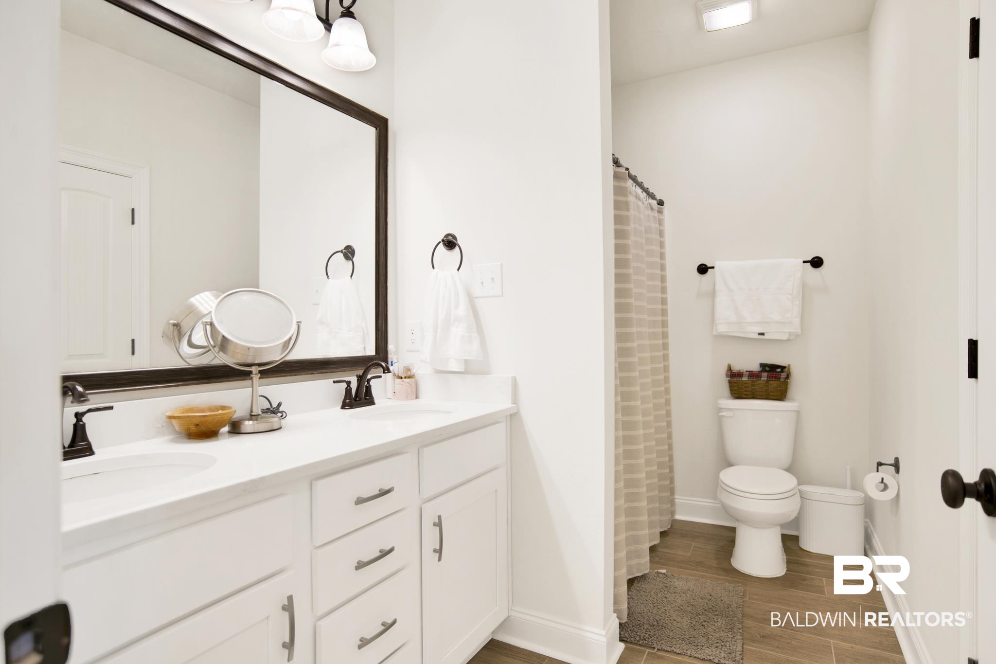 22258 Hibiscus Circle Foley, AL 36535 - Photo 20 of 26 Bathroom with double vanity, wood finished floors, toilet, and a sink