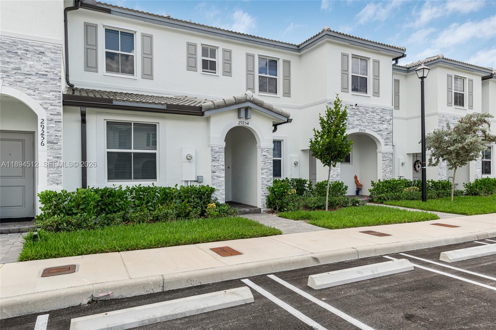 29254 Southwest 163rd Court Homestead, FL 33033 - Photo 1 of 29 a front view of a house with a yard and a garage