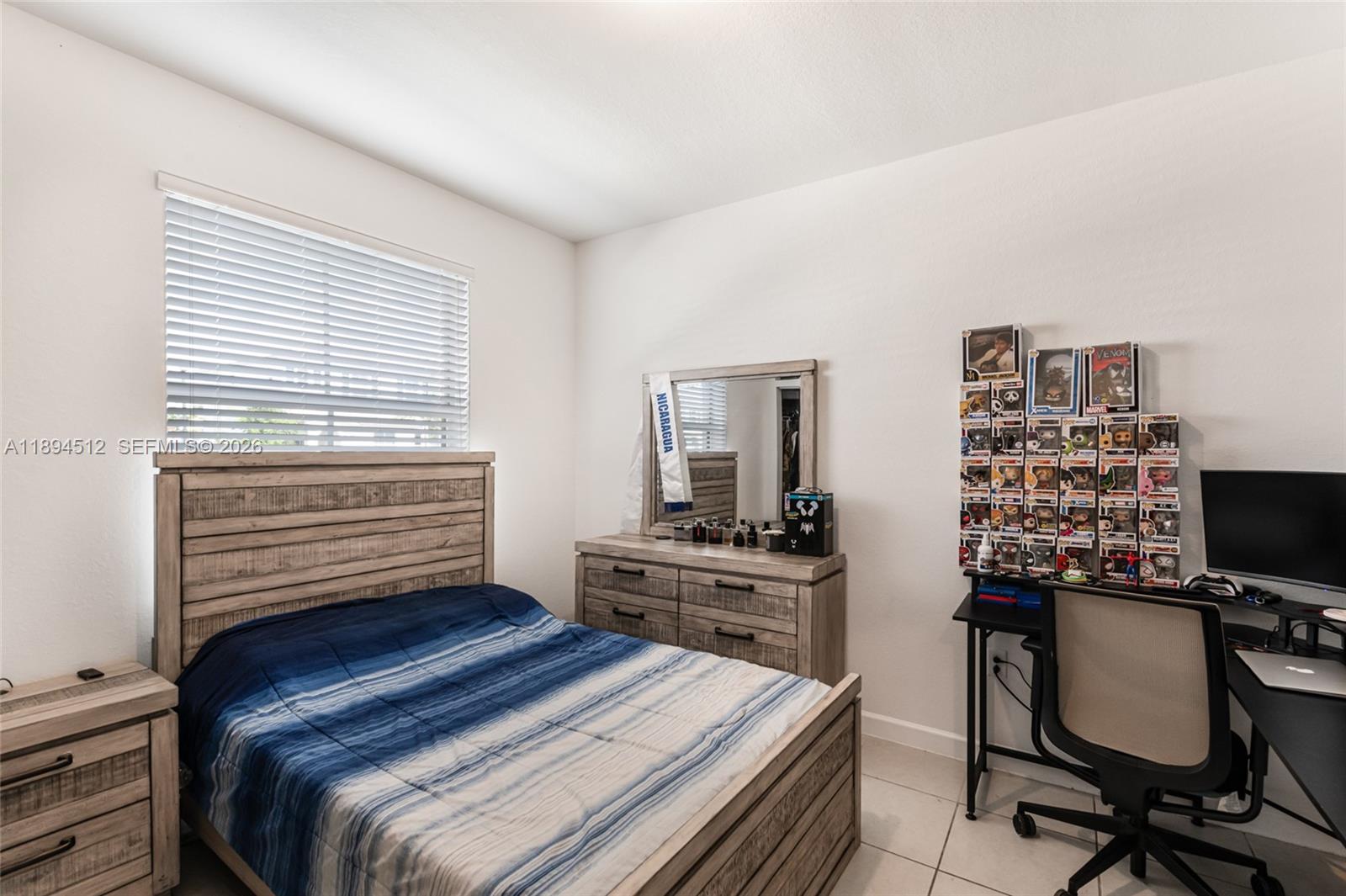 29254 Southwest 163rd Court Homestead, FL 33033 - Photo 11 of 29 a bedroom with a bed and a computer on a desk