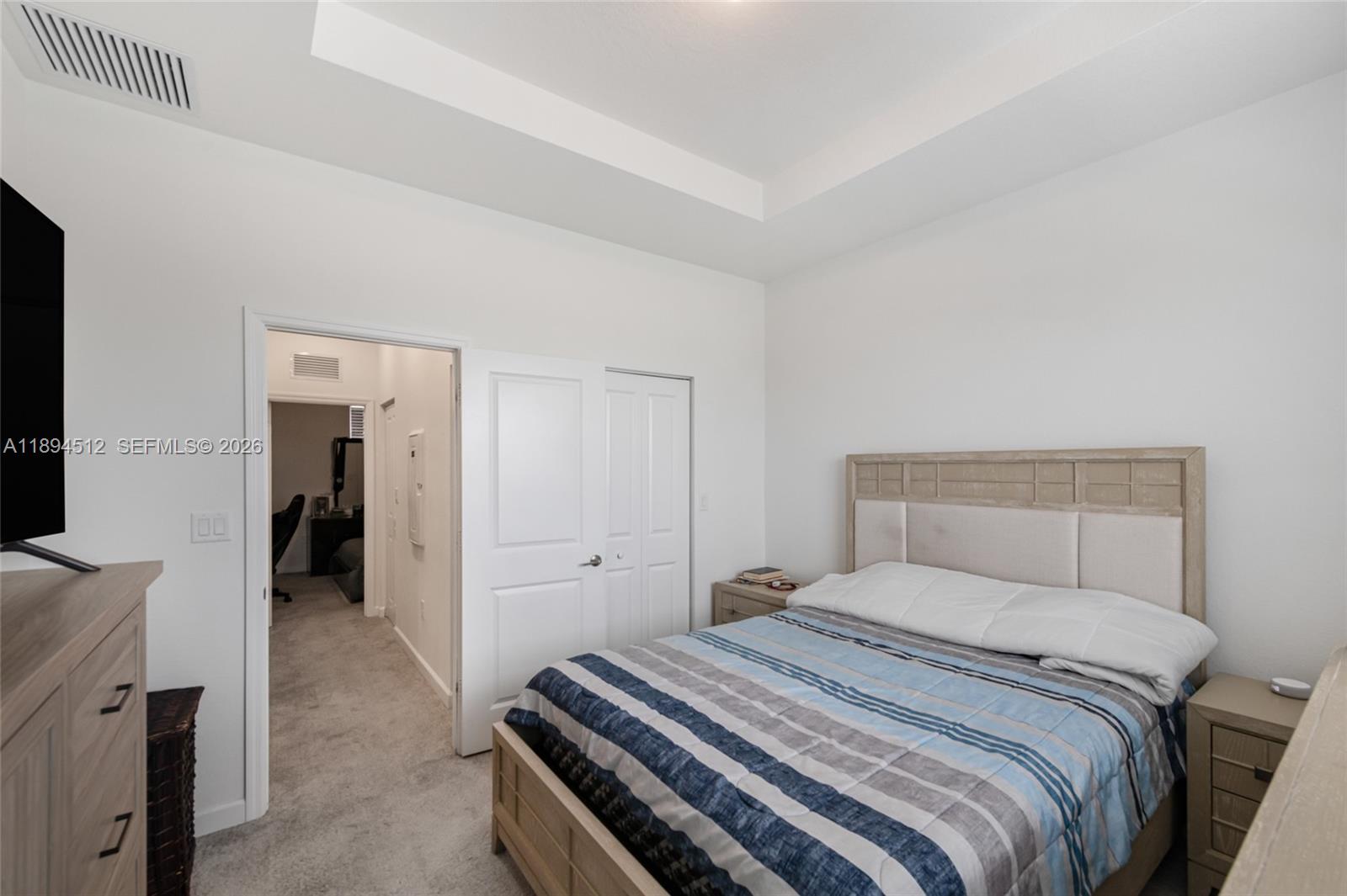 29254 Southwest 163rd Court Homestead, FL 33033 - Photo 13 of 29 a bedroom with a bed and a chandelier