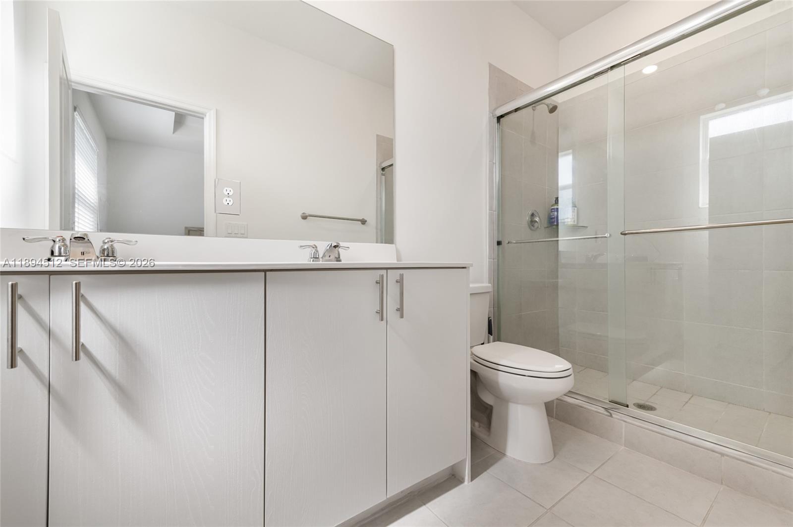 29254 Southwest 163rd Court Homestead, FL 33033 - Photo 14 of 29 a bathroom with a sink a toilet and shower