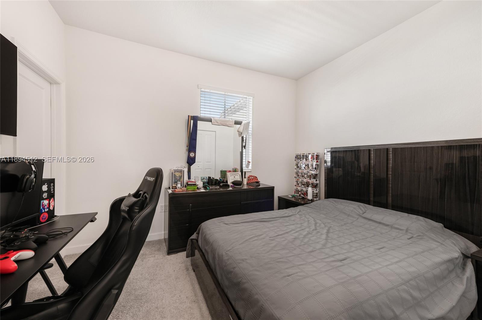 29254 Southwest 163rd Court Homestead, FL 33033 - Photo 16 of 29 a bedroom with a bed and a flat tv screen on a dresser