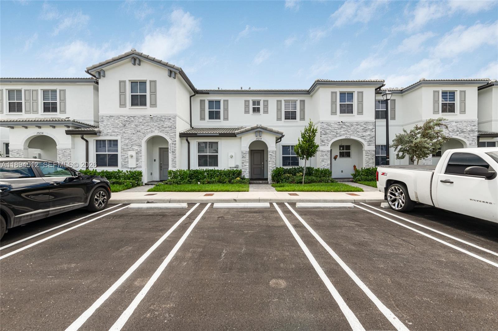 29254 Southwest 163rd Court Homestead, FL 33033 - Photo 20 of 29 a view of multiple houses with cars parked