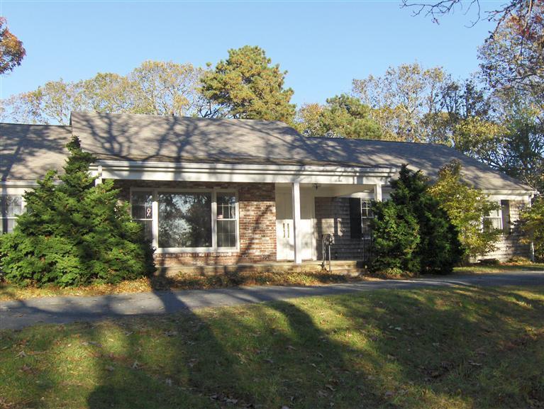 a front view of a house with a yard table and chairs