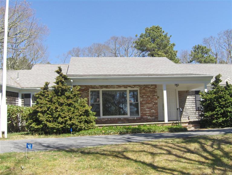 110 Round Cove Road Chatham, MA 02633 - Photo 16 of 16 a view of a white house with a large window and a yard with plants