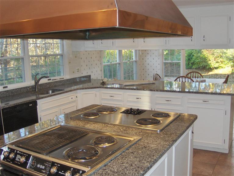 110 Round Cove Road Chatham, MA 02633 - Photo 3 of 16 a kitchen with a stove a sink and a granite counter tops
