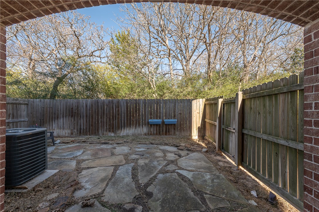 1425 West Villa Maria Road, Unit 103 Bryan, TX 77801 - Photo 24 of 30 Fenced backyard featuring a flagstone patio