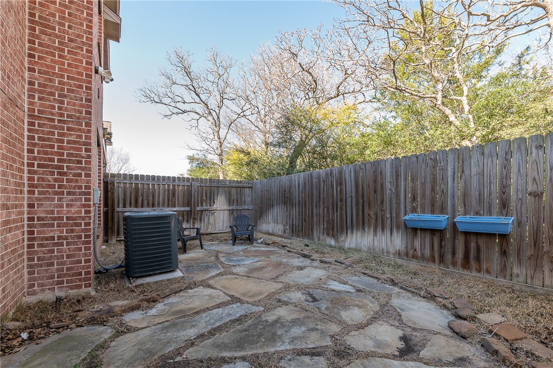 1425 West Villa Maria Road, Unit 103 Bryan, TX 77801 - Photo 25 of 30 Fenced backyard with flagstone patio