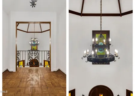 a view of a livingroom with wooden floor and a chandelier
