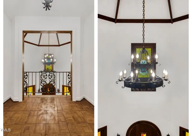 a view of a livingroom with wooden floor and a chandelier