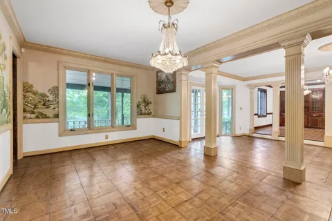 a view of empty room with wooden floor