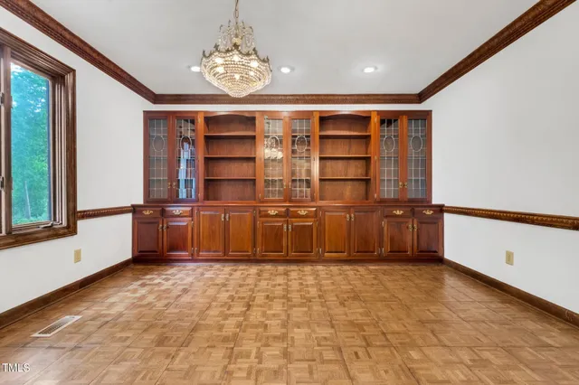 a view of a room with large windows and a chandelier