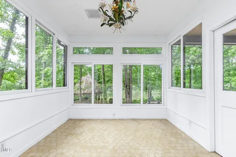 a kitchen with granite countertop a stove a sink and a chandelier