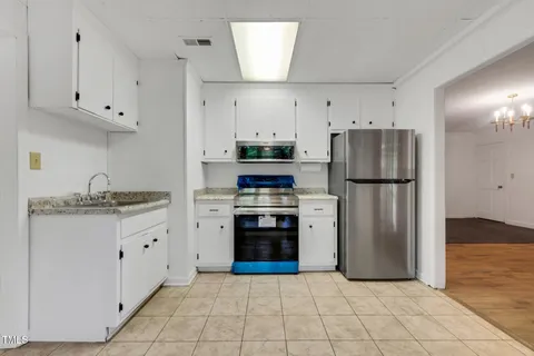 a view of a garden with large trees