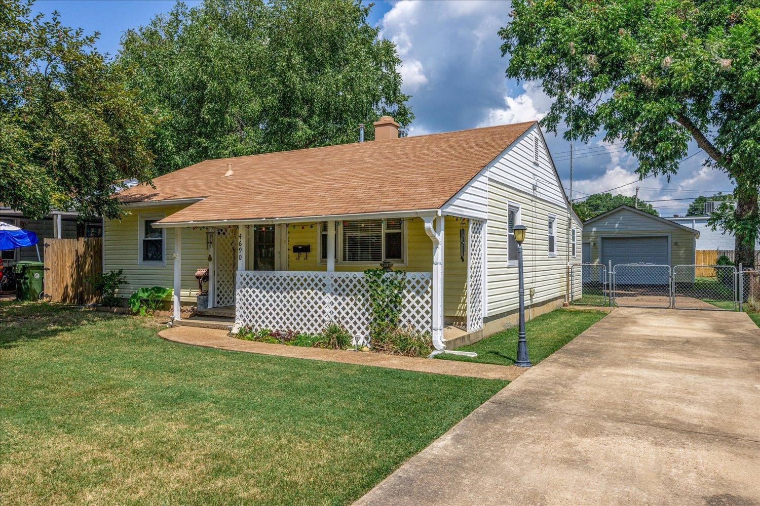 4690 Montgomery Road Millington, TN 38053 - Photo 2 of 26 Bungalow-style home featuring a chimney, concrete driveway, an outdoor structure, a garage, and covered porch