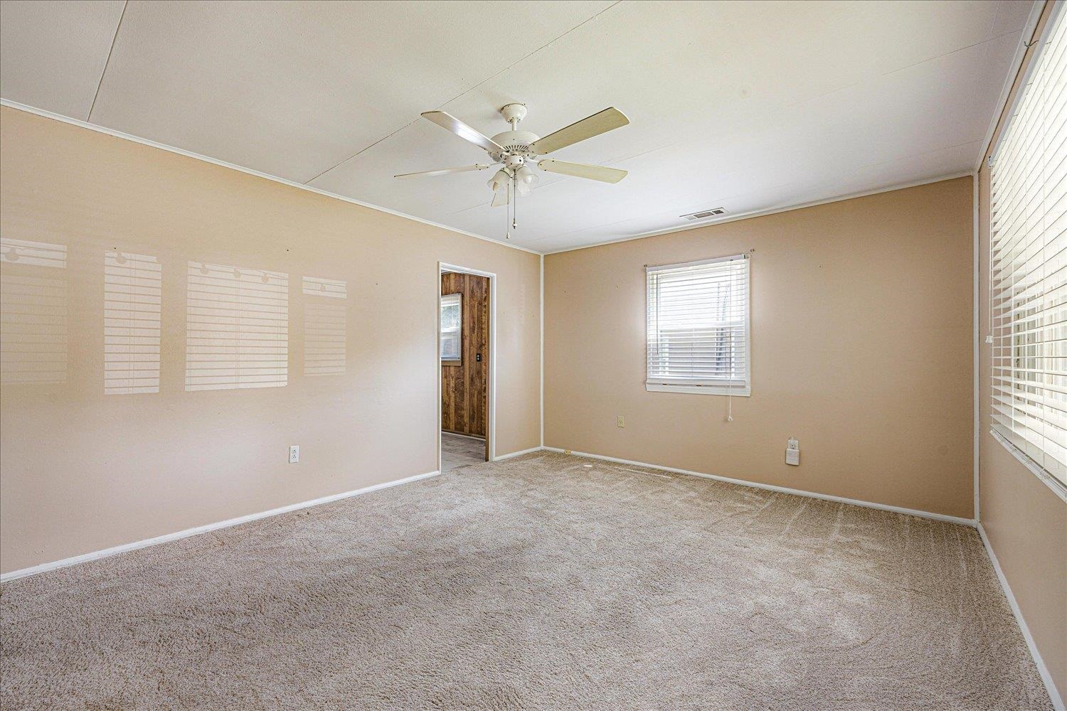 4690 Montgomery Road Millington, TN 38053 - Photo 8 of 26 Spare room with light colored carpet, a ceiling fan, and crown molding