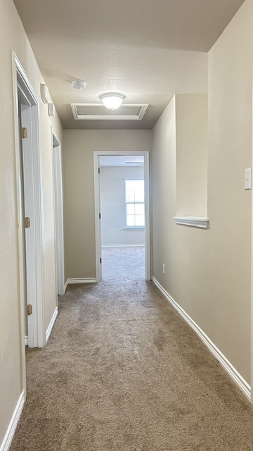 5211 Viewpoint Drive Austin, TX 78744 - Photo 22 of 29 This pic is taken from the upstairs full bathroom. There are 2 bedrooms to the left, the primary bedroom is straight ahead, and the laundry room is to the right.