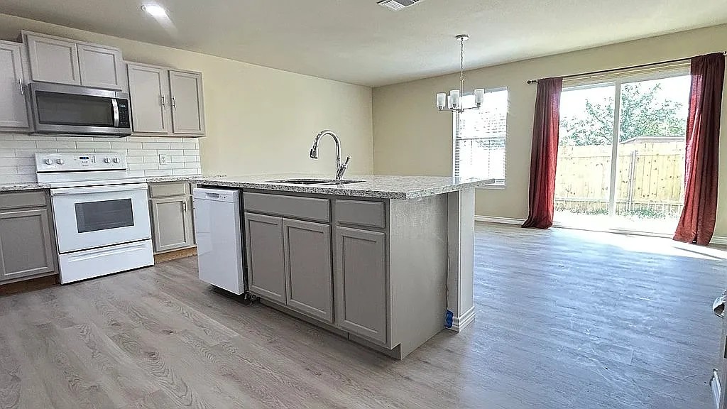 5211 Viewpoint Drive Austin, TX 78744 - Photo 9 of 29 The kitchen is open to the back living space that could be a comb dining room and 2nd lower-level living space.
