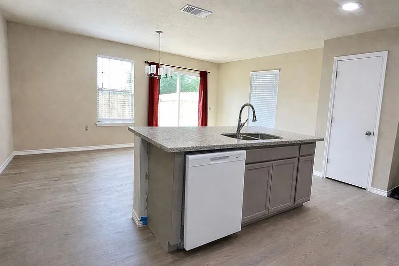 5211 Viewpoint Drive Austin, TX 78744 - Photo 10 of 29 The kitchen is open to the back living space that could be a comb dining room and 2nd lower-level living space.