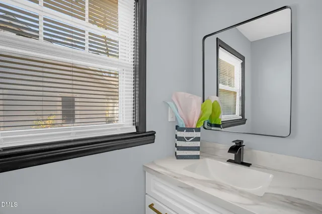 a view of a big room with carpet and a window