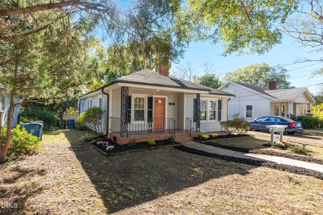 a front view of a house with a garden and sitting area